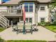 Paved patio with outdoor table and chairs that extends from a two-story home with a well-maintained yard at 13069 Abraham Run, Carmel, IN 46033