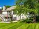 Inviting backyard featuring a patio and deck perfect for entertaining and relaxing under the shade of mature trees at 13069 Abraham Run, Carmel, IN 46033