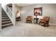Finished basement area with carpet flooring, white stairs, and cozy seating arrangement with decorative accents at 13069 Abraham Run, Carmel, IN 46033