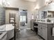 Elegant bathroom showcasing double sinks, tile flooring, modern fixtures, and a soaking tub with backyard view at 13069 Abraham Run, Carmel, IN 46033