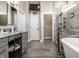 Modern bathroom featuring double vanity, tiled floor, walk-in shower, and a luxurious soaking tub at 13069 Abraham Run, Carmel, IN 46033