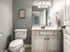 Neutral bathroom with a white vanity, toilet, and modern fixtures at 13069 Abraham Run, Carmel, IN 46033