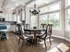 Sunlit breakfast nook features a round wood table and views of the landscaped yard at 13069 Abraham Run, Carmel, IN 46033