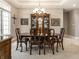 Formal dining room with traditional wood furniture, chandelier, and large window at 13069 Abraham Run, Carmel, IN 46033