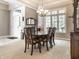 Formal dining room features wood furniture, chandelier, and bright natural lighting at 13069 Abraham Run, Carmel, IN 46033