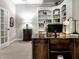 Elegant home office featuring custom built-in bookshelves, a large wood desk, and a cozy, carpeted floor at 13069 Abraham Run, Carmel, IN 46033