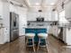 Modern kitchen featuring an island, stainless steel appliances, white cabinets, and hardwood floors at 13069 Abraham Run, Carmel, IN 46033