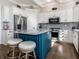 Kitchen features a gray backsplash, stainless appliances, and a blue kitchen island with seating at 13069 Abraham Run, Carmel, IN 46033