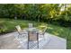 Cozy backyard patio with table and chairs, string lights, and lush green lawn at 1309 Rolling Ct, Westfield, IN 46074