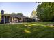 Backyard featuring a patio with outdoor seating, a firepit, and a spacious lawn at 1309 Rolling Ct, Westfield, IN 46074