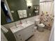Bathroom with double sink vanity, tiled shower, and decorative wall accents at 1309 Rolling Ct, Westfield, IN 46074