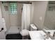 Updated bathroom with glass block window, white subway tile shower, and modern fixtures at 1309 Rolling Ct, Westfield, IN 46074