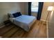 Serene bedroom boasting natural light, hard wood floors, and a comfortable bed at 1309 Rolling Ct, Westfield, IN 46074