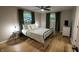 Cozy bedroom with hardwood floors, black metal bed frame, and abundant natural light at 1309 Rolling Ct, Westfield, IN 46074