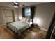 Relaxing bedroom featuring a metal bed frame, wood floors, and neutral wall paint at 1309 Rolling Ct, Westfield, IN 46074