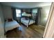 Shared bedroom with bunkbeds and twin bed, bright windows and wood-look laminate floors at 1309 Rolling Ct, Westfield, IN 46074
