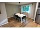 Bright dining room with hardwood floors, neutral walls, a modern chandelier, and ample seating for six at 1309 Rolling Ct, Westfield, IN 46074