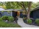 Charming blue home featuring a well-maintained front yard, mature tree and beautiful landscaping at 1309 Rolling Ct, Westfield, IN 46074
