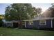 Charming blue home featuring a well-maintained front yard, mature tree and beautiful landscaping at 1309 Rolling Ct, Westfield, IN 46074