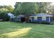 Charming blue home featuring a well-maintained front yard, mature tree and beautiful landscaping at 1309 Rolling Ct, Westfield, IN 46074
