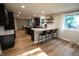 Bright kitchen featuring black cabinets, marble counters, and a spacious island with seating at 1309 Rolling Ct, Westfield, IN 46074