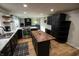 Modern kitchen with stainless steel appliances, dark cabinets, marble countertops, and a center island at 1309 Rolling Ct, Westfield, IN 46074