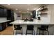 Spacious kitchen with marble counters, tile backsplash, floating shelves, and black cabinets at 1309 Rolling Ct, Westfield, IN 46074
