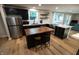 Modern kitchen with stainless steel appliances, dark cabinets, marble countertops, and a center island at 1309 Rolling Ct, Westfield, IN 46074