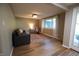 Bright living room featuring wood floors, neutral walls, a large window, and comfortable seating at 1309 Rolling Ct, Westfield, IN 46074