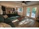Inviting living room with cozy sectional, French doors to backyard, and open kitchen view at 1309 Rolling Ct, Westfield, IN 46074