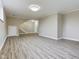 Open basement featuring vinyl floors, a staircase, a utility door, and recessed lighting at 1325 Northcrest Dr, Anderson, IN 46012