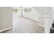 Open basement featuring vinyl floors, a staircase, and two windows for natural light at 1325 Northcrest Dr, Anderson, IN 46012