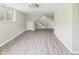 Spacious basement featuring vinyl floors, a staircase, a utility door, and a window at 1325 Northcrest Dr, Anderson, IN 46012