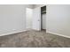 Bright bedroom featuring plush carpeting, neutral walls, and closet with white doors at 1325 Northcrest Dr, Anderson, IN 46012
