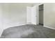 Bright bedroom featuring plush carpeting, neutral walls, and closet with white doors at 1325 Northcrest Dr, Anderson, IN 46012