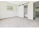 Bedroom with carpet, a sliding barn door leading to the bathroom, and a window offering natural light at 1325 Northcrest Dr, Anderson, IN 46012