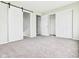 Spacious bedroom featuring gray carpet, access to closets, and neutral-colored walls for a modern aesthetic at 1325 Northcrest Dr, Anderson, IN 46012