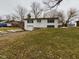 Charming two-story white home with an attached garage and a well-maintained front yard on a cloudy day at 1325 Northcrest Dr, Anderson, IN 46012