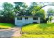 Charming split-level home featuring a front-facing garage and lush green landscaping in a peaceful neighborhood at 1325 Northcrest Dr, Anderson, IN 46012