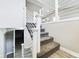 Modern staircase featuring white railings, carpeted steps, and contemporary design elements on a neutral color palette at 1325 Northcrest Dr, Anderson, IN 46012