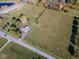 Expansive aerial view showcasing a large grassy lot with mature trees, a home and road frontage at 13518 (3 Lots) Promise Rd, Fishers, IN 46038