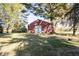 Exterior shot of red barn with white door surrounded by mature trees at 13518 (3 Lots) Promise Rd, Fishers, IN 46038