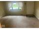 Carpeted living room featuring natural light from a large window at 13518 (3 Lots) Promise Rd, Fishers, IN 46038