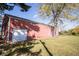 Spacious outbuilding with a roll up door surrounded by a well maintained lawn and mature trees at 13518 (3 Lots) Promise Rd, Fishers, IN 46038