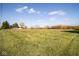 Wide open yard, offering ample space for activities, under a sky with scattered clouds at 13518 (3 Lots) Promise Rd, Fishers, IN 46038