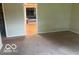 Spacious living room with neutral walls and carpet adjacent to a recreation room at 13518 Promise Rd, Fishers, IN 46038