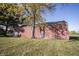 Angled view of the large red outbuilding or barn with multiple doors on the property's grounds at 13518 Promise Rd, Fishers, IN 46038