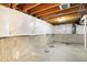 Unfinished basement with vapor barrier, showing plumbing, concrete flooring, and electrical panel at 1384 Horse Shoe, Greenwood, IN 46143