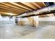 Large unfinished basement featuring concrete flooring, exposed wood beams, and the framework for future stairs at 1384 Horse Shoe, Greenwood, IN 46143