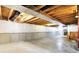 Spacious unfinished basement with exposed wood beams, concrete floor, and white plastic sheeting on the foundation walls at 1384 Horse Shoe, Greenwood, IN 46143
